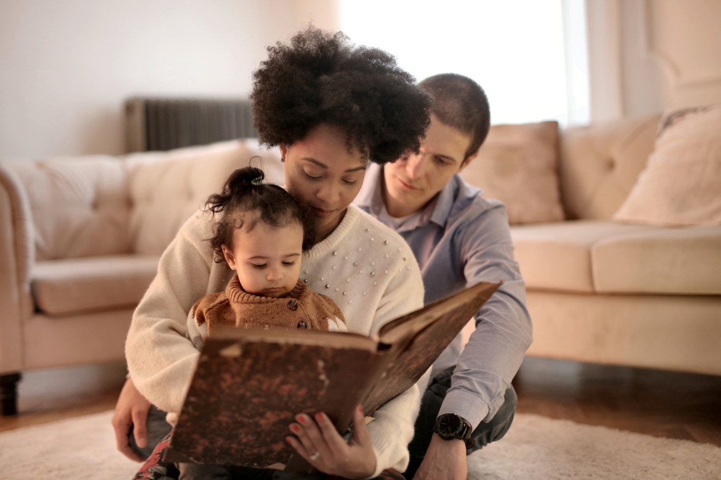 Mother and father reading to a child